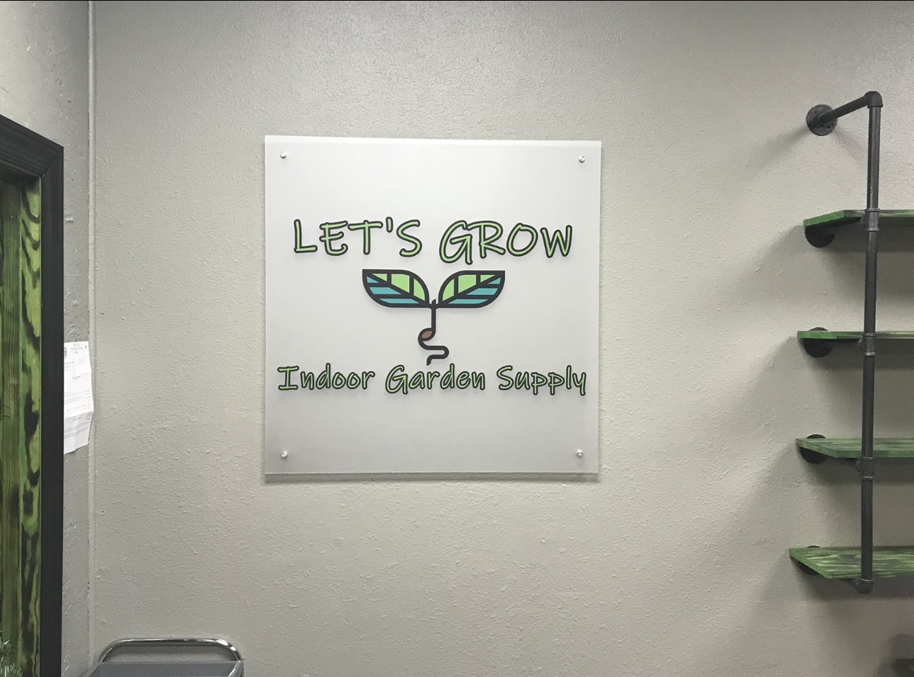 Let’s Grow Indoor Garden Supply wall sign mounted with four metal standoffs